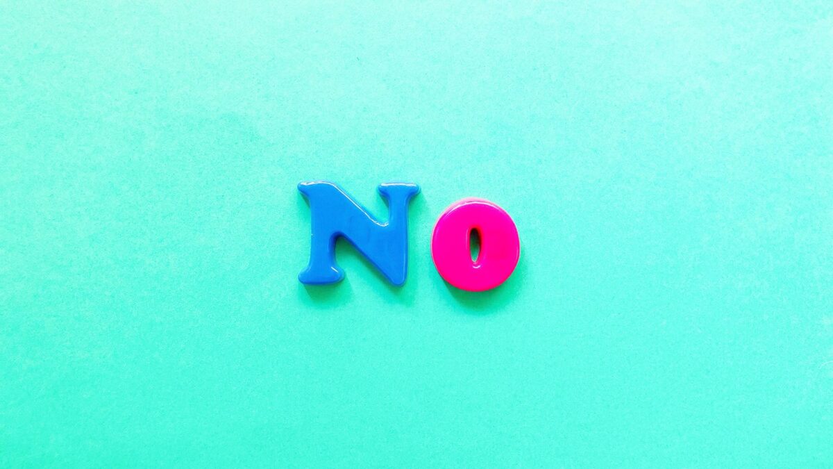 A blue letter and pink letter on a green background