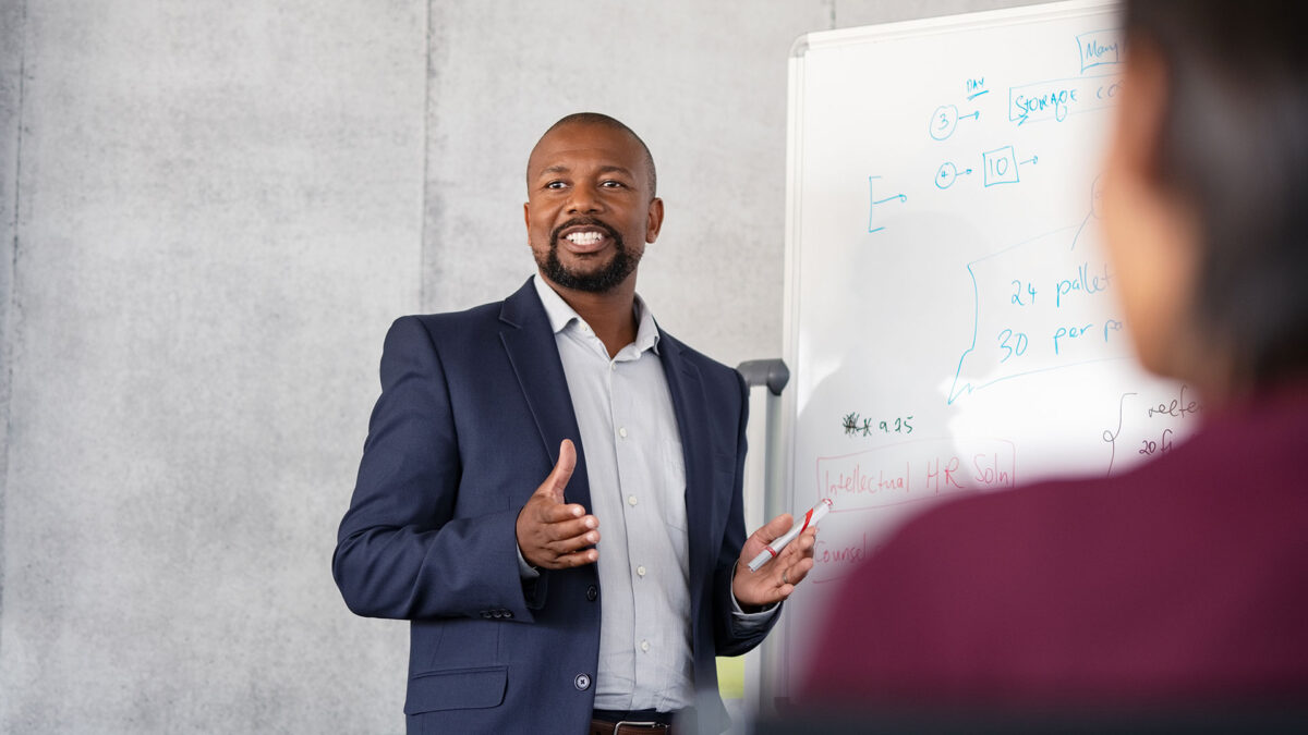 A man in a suit is giving a presentation.