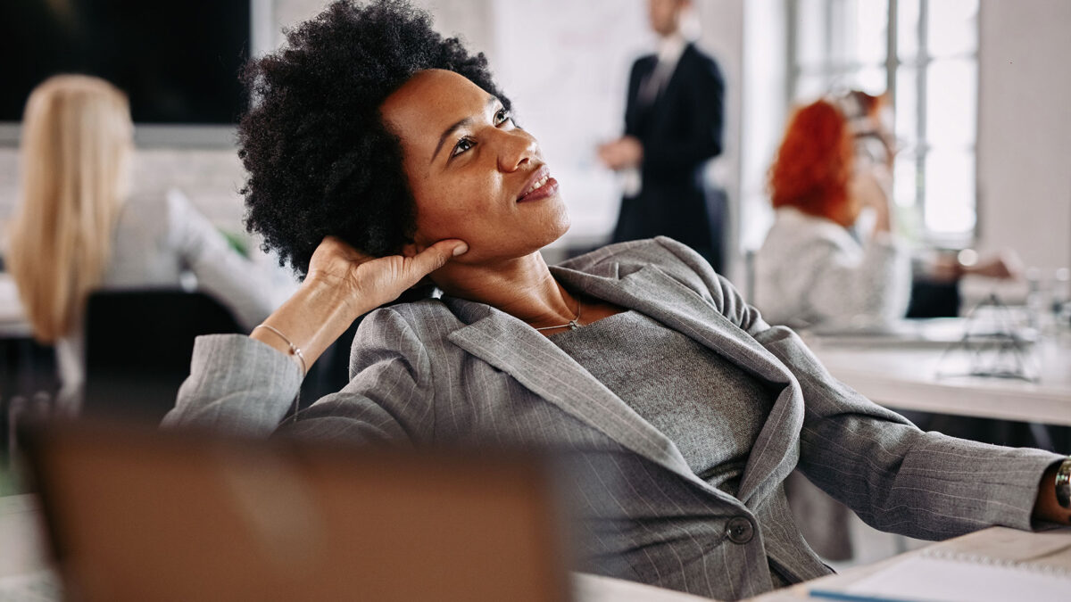 A woman sitting in front of a table with other people.