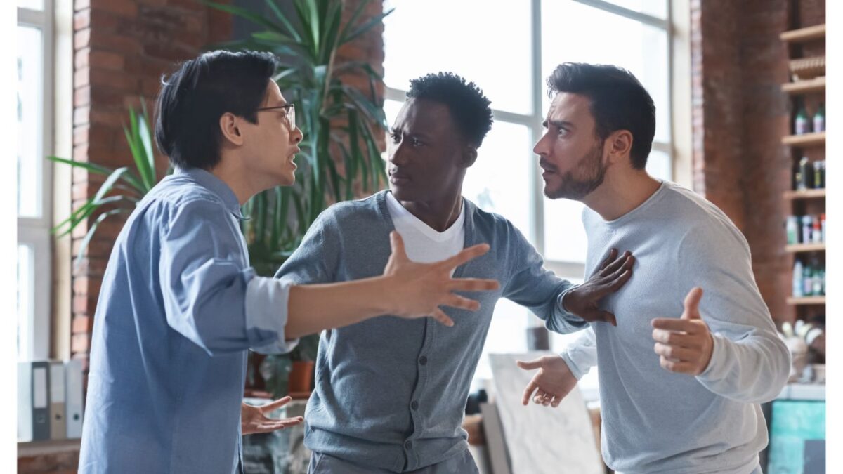 Three men are arguing in a room.